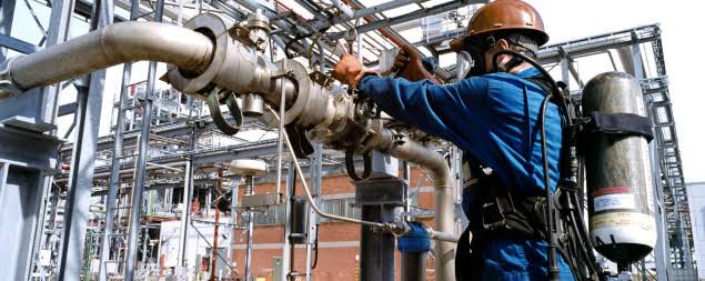 Technician working on industrial pipework