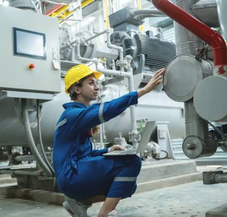 Technician inspecting industrial plant equipment